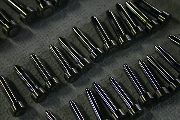 Precision metal components and fasteners arranged for quality inspection